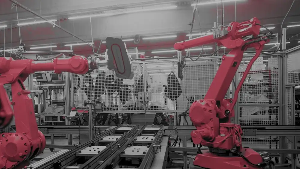 Robotic arms on an automated production line, the kind of operational technology an attack can bring to a stop