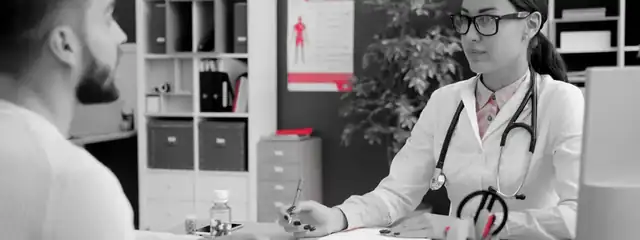 A doctor reviewing notes with a patient