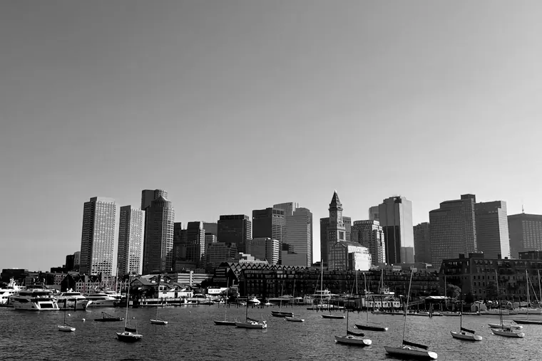 The downtown Boston skyline seen from Boston Harbor, with sailboats in the foreground