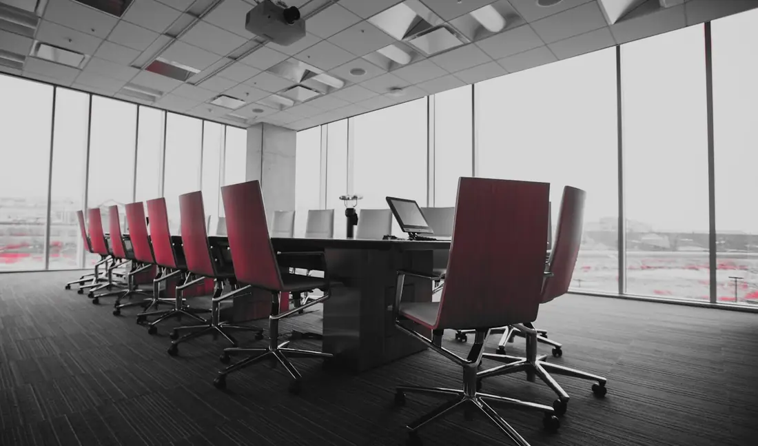 An empty boardroom with a long conference table, where directors review cyber risk