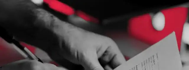 Hands signing an insurance document